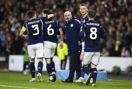Steve Clarke with his players after Scott McTominay had scored the second against Spain.
