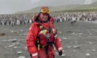 Polar tour guide Bill Smith p-p-p-poses with penguins