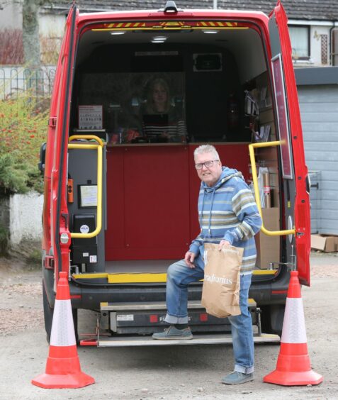 John Forrester, right, uses the mobile Post Office van at Dores, near Inverness