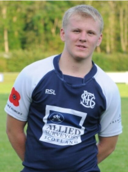 Harris, aged 18, in his Selkirk rugby shirt