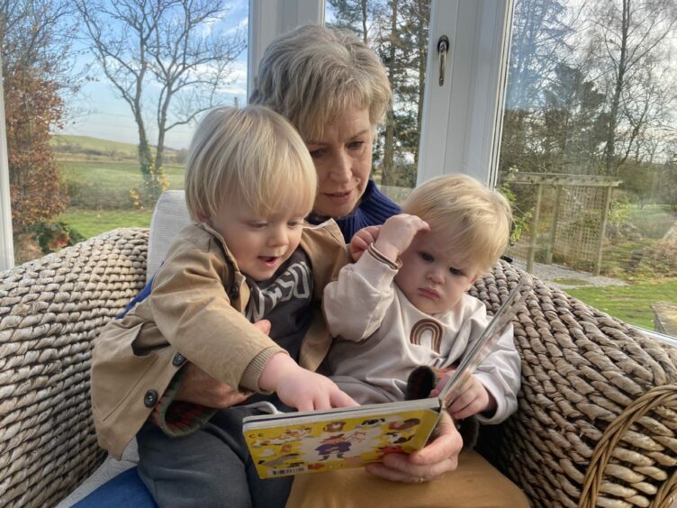 Author Sally Magnusson reading to grandsons Wolfie, two, left, and 18-month-old Atli