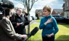 Nicola Sturgeon talks to reporters outside her home in Uddingston yesterday