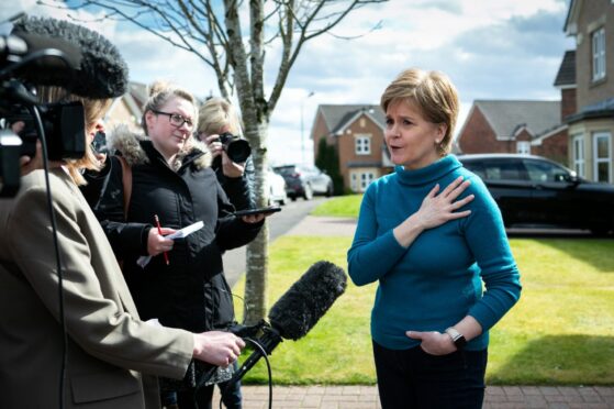 Nicola Sturgeon talks to reporters outside her home in Uddingston yesterday