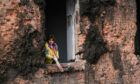 A resident clears debris from her home after a missile strike – one of many in the industrial town of Kostiantynivka in eastern Ukraine