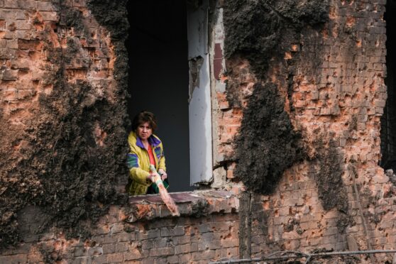 A resident clears debris from her home after a missile strike – one of many in the industrial town of Kostiantynivka in eastern Ukraine