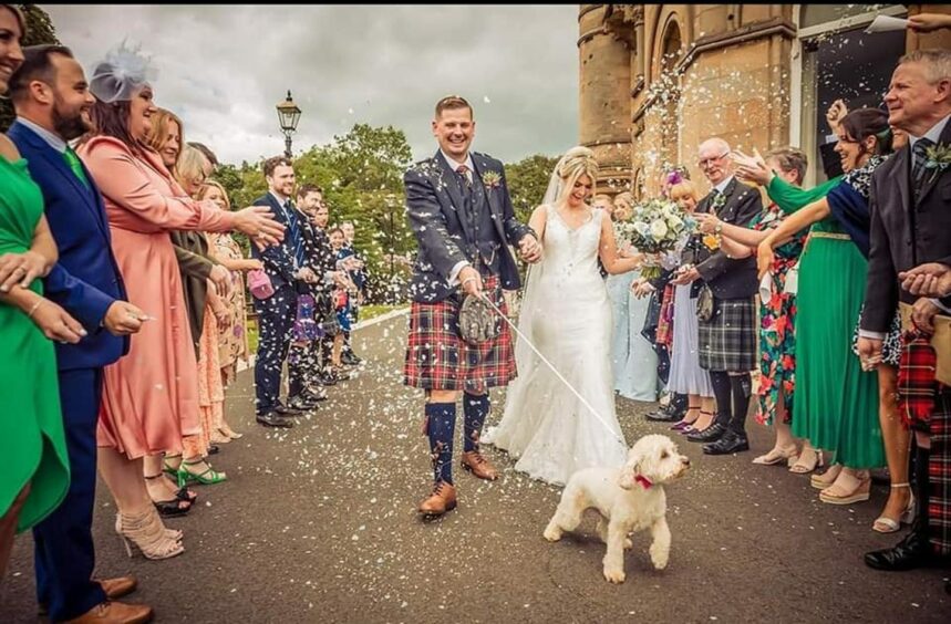 Wedding couple and dog service Woofy Weddings.