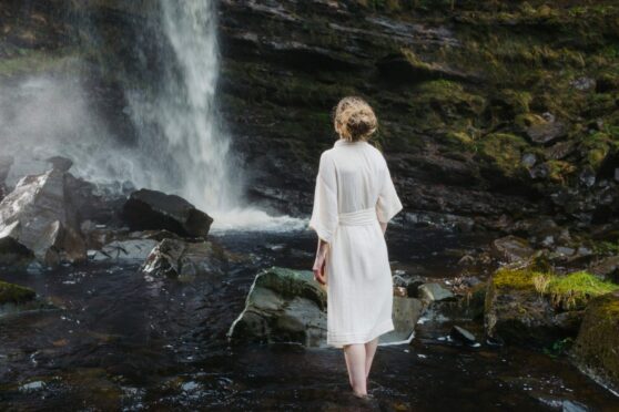 ARRAN Sense of Scotland model in front of waterfall