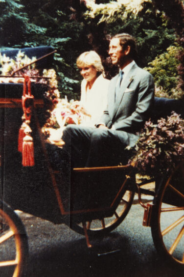 Diana and Charles in honeymoon carriage after 1981 wedding