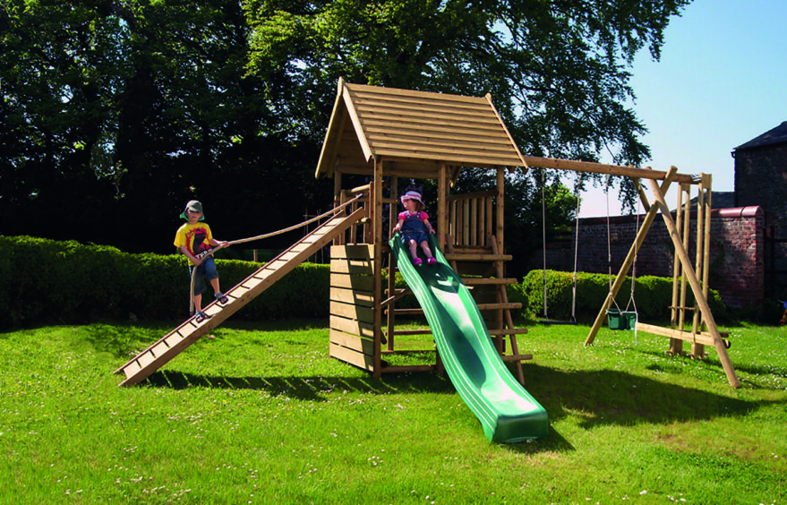 Children playing on a garden slide.