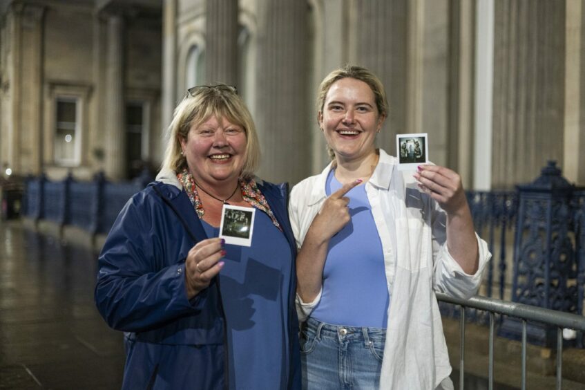 Sarah and Carol with their Polaroids.