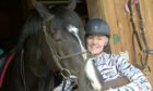 Marion MacLennan with her horse Lenny at home in Croy, Inverness