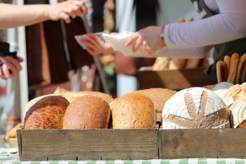 Local market stall displaying freshly made bread.