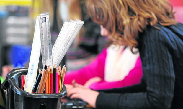 Primary School children at work in a classroom. Image: PA