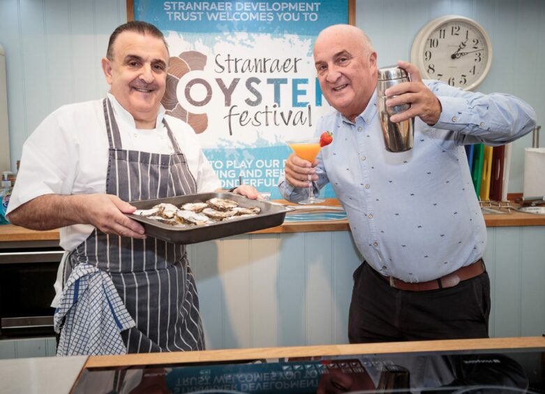 Douglas and Massimo serve up oysters.
