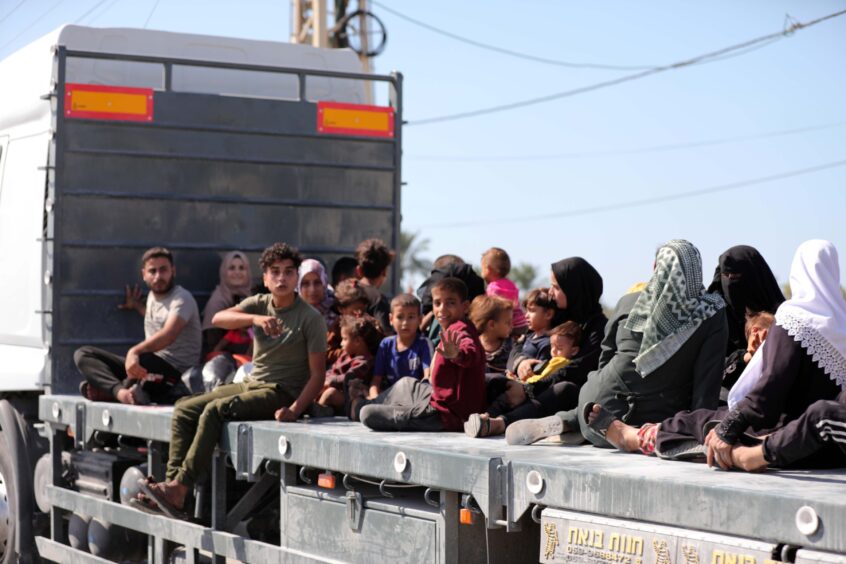 Palestinians on the back of a truck leave Gaza City as they flee from their homes following the Israeli army’s evacuation warning on Friday.