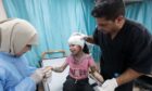 Medics treat a wounded child at Al-Aqsa Hospital in the city of Deir al-Balah in the central Gaza Strip.
