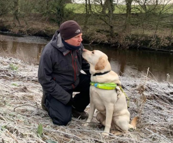Scott Cunningham with his guide dog Lincoln in Chatelherault Country Park.