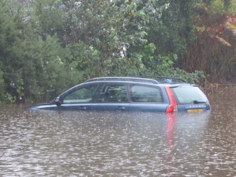 A car is submerged after heavy downpours hit Oban.