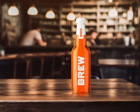 bottle of Scoffable BREW on a table in a restaurant