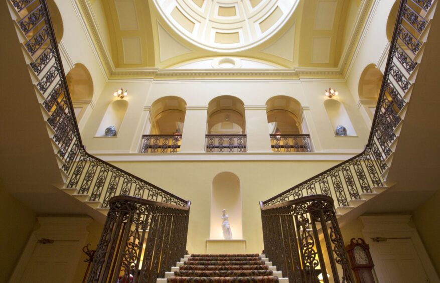 Interior of Stobo Castle stairwell in grand entry. It is large and ornate.