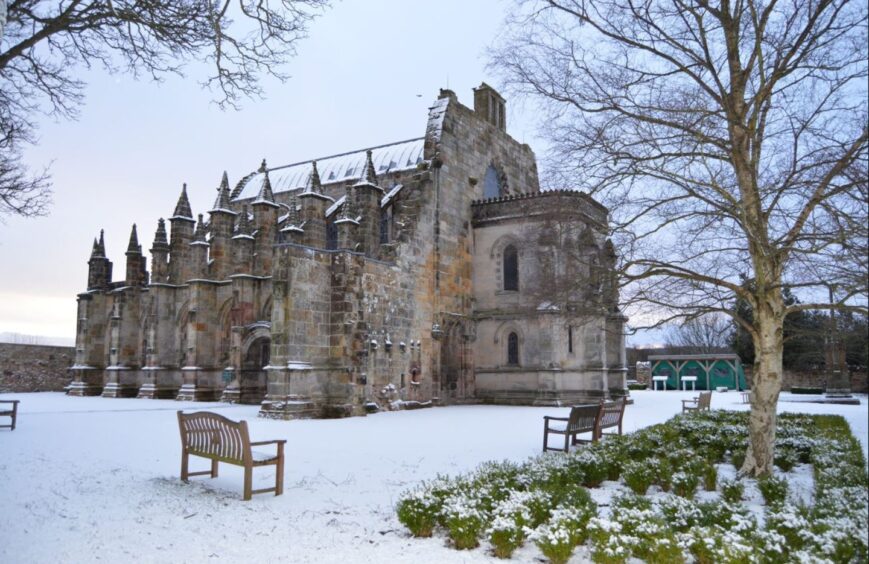 Rosslyn Chapel in winter covered in snow.