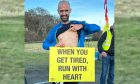 Mike Raffan points to his heart after winning the Golspie Ultra-marathon.