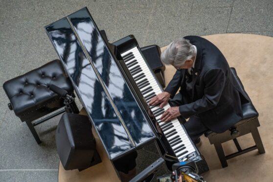 Harry Hussey performs in the Christmas special of The Piano at St Pancras station.