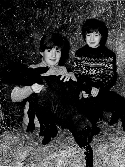 Children Robert and Carol with spring lambs.