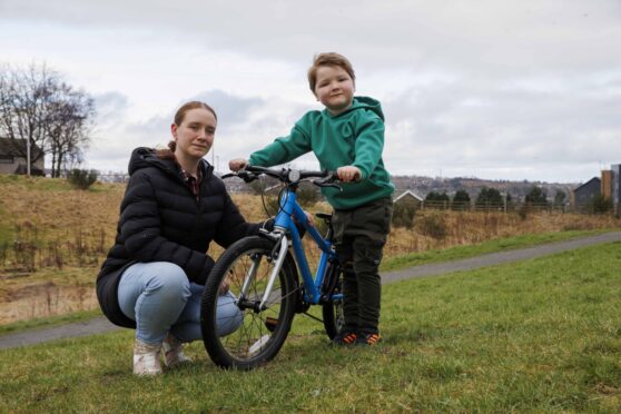 Hunter proudly shows off his bike with mum Kelly.
