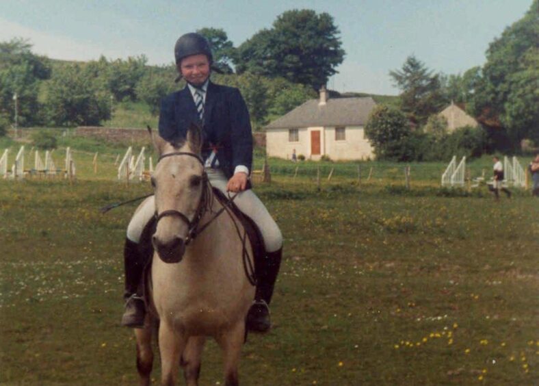 A teenage Emma Caldwell on horseback.