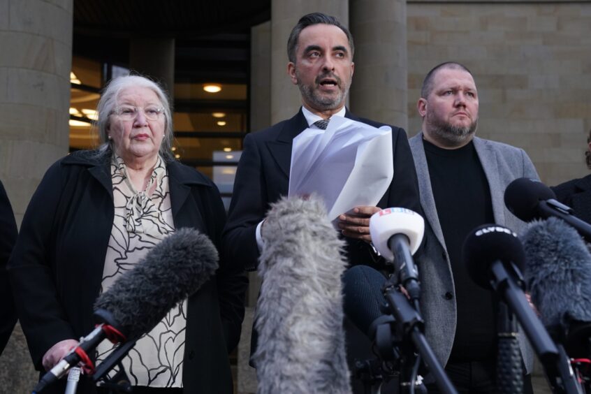 Solicitor Aamer Anwar, beside mother Margaret Caldwell and other family members, reads out a statement outside Glasgow High Court after Iain Packer was found guilty of murdering Emma.