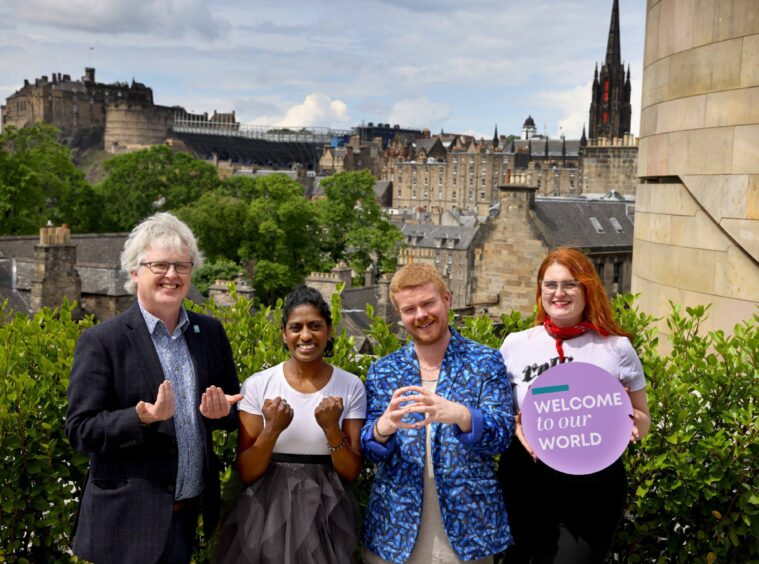 Members of the Edinburgh Deaf Festival team sing at the launch of their 2023 event.