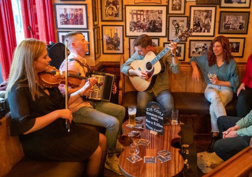 Group of musicians playing in a pub in Ireland.
