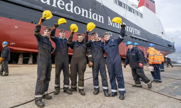 Apprentice shipbuilders alongside the MV Glen Rosa before it was launched.