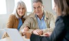 Mature couple speaking with an adviser.