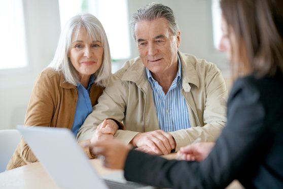 Mature couple speaking with an adviser.