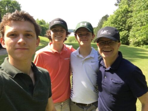 Tom Holland, left, with brothers Sam and Harry and dad Dominic.