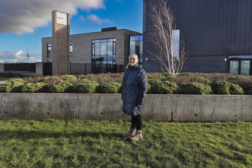 Margaret Jaconelli stands at the exact spot that was the entrance to her old home, February 2024.