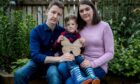 Mhairi and Lee Hayes with son Jack, who holds a memorial to his sister Niamh, who died before he was born. Mhairi was suffering from pre-eclampsia.