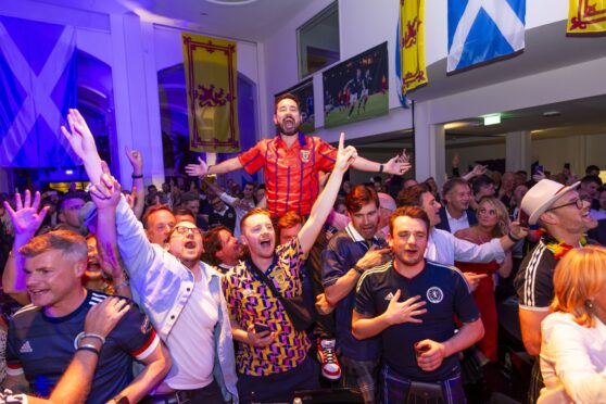 Show Bavaria how Scots party? It’s all in the Line Of Duty for actor Martin Compston as he leads the singing at the Isarpost building in Munich on the eve of the opening game.