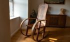 A rocking chair, a Bespoke Adam Stone furniture piece.