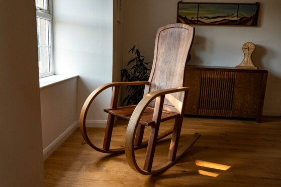 A rocking chair, a Bespoke Adam Stone furniture piece.