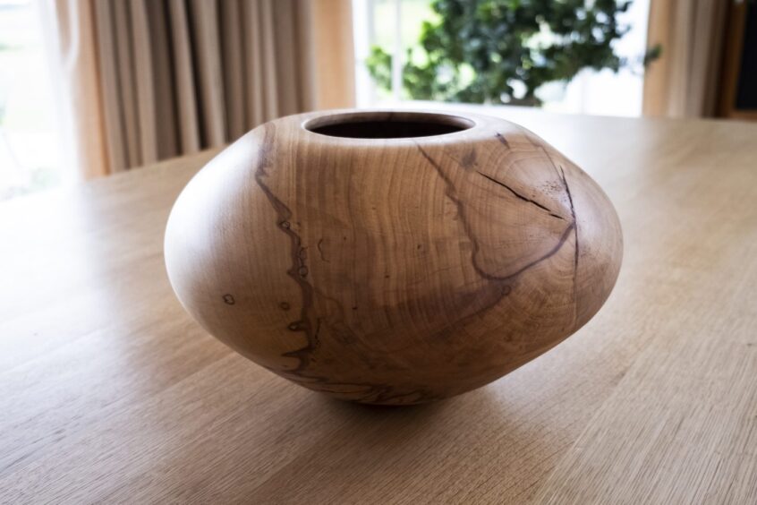 A hollow wooden vase.