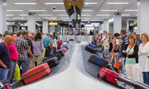 Passengers collect their bags at the carousel.