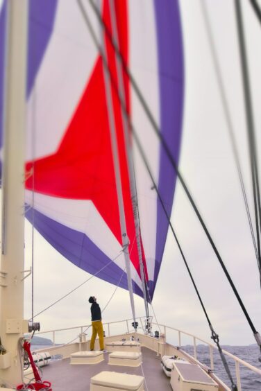 Unfurling the spinnaker.