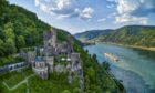 A Viking cruise on the Rhine River passes Rheinstein Castle, Germany.