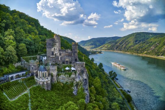 A Viking cruise on the Rhine River passes Rheinstein Castle, Germany.