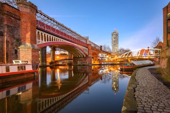 Manchester’s tallest building, Beetham Tower, is reflected in one of the city’s many canals