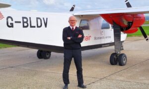 Pilot Colin McAllister with the Loganair plane he flew to transport the film stars and crew – and he even made a scene in the movie.