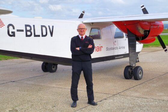 Pilot Colin McAllister with the Loganair plane he flew to transport the film stars and crew – and he even made a scene in the movie.